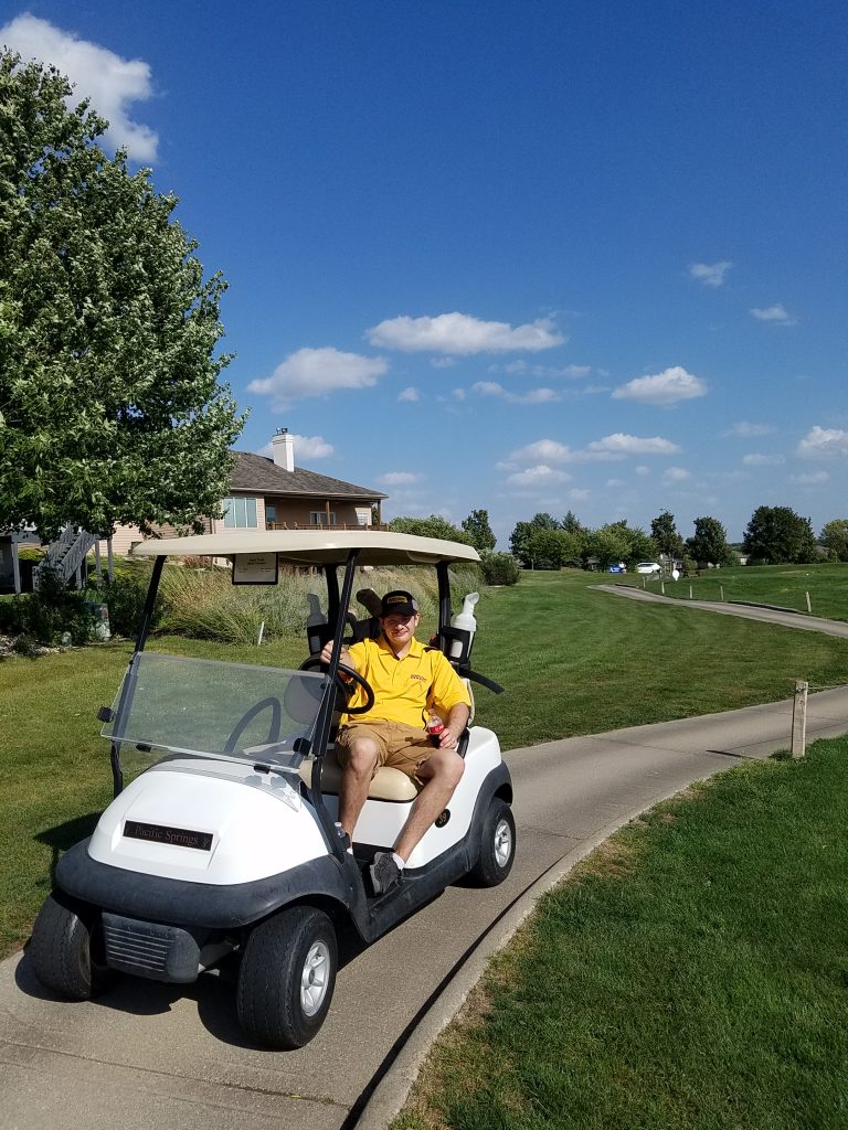 CPP Team Member driving a golf cart